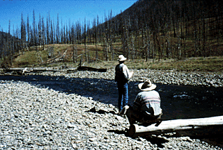 Alex watches as one of the riders tries his hand at fly fishing.