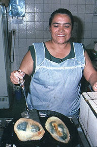 Dolores Duran cooks up some chilles rellenos in the food market of Tequisquipan